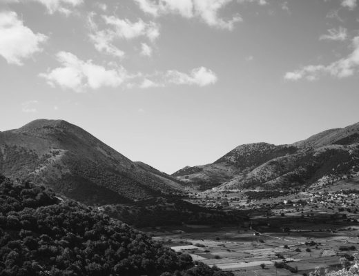A stunning black and white aerial view capturing scenic countryside hills and rural landscape.