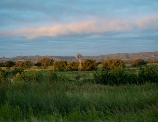 Scenic view of a countryside windmill under a cloudy sky in Cรณrdoba, Argentina.