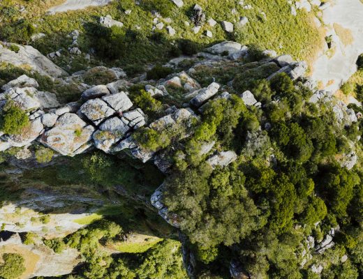 Aerial shot capturing the natural rocky formations and vegetation in Greece, showcasing an intricate landscape.